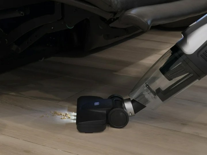 Using the Black + Decker 3-in-1 corded vacuum to clean beneath a recliner.