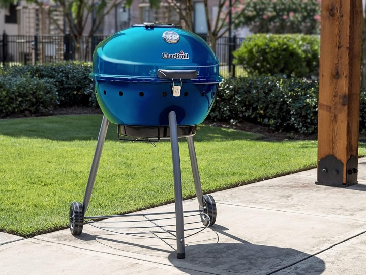 The Char-Broil Kettleman charcoal grill on a backyard patio.