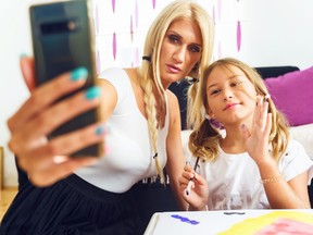 Mother and daughter taking selfie.