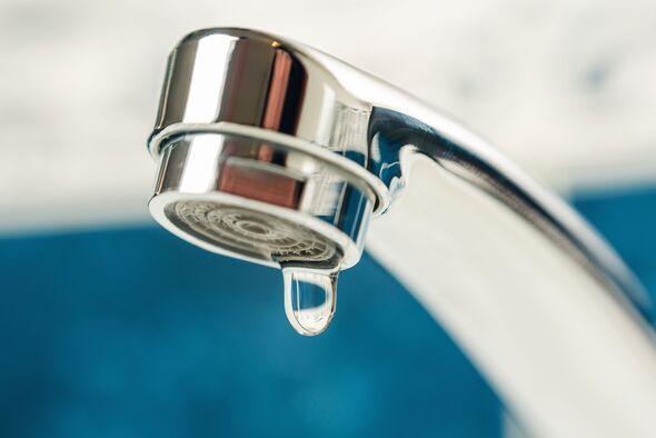 A drop of water drips from a leaky faucet