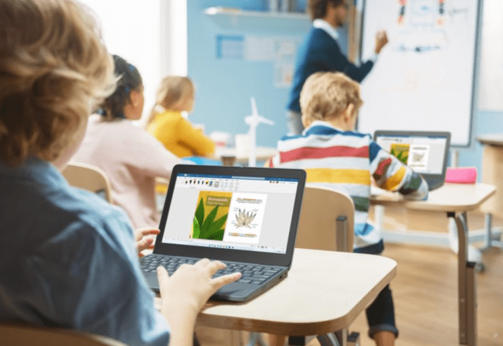 A child using a Lenovo 500w 2-in-1 Laptop in a classroom.