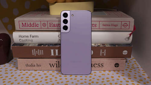 Samsung Galaxy S22 Bora Purple Leaning Against Books