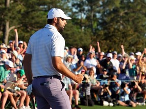 Scottie Scheffler reacts after making birdie on the 18th green during the third round of the 2024 Masters Tournament at Augusta National Golf Club in Augusta, Ga., Saturday, April 13, 2024.