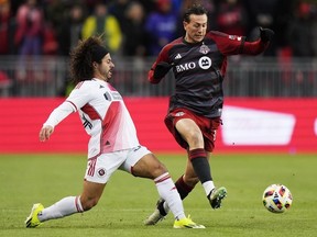 Toronto FC’s Federico Bernardeschi tries to get around New England Revolution’s Ryan Spaulding at BMO Field last night.  Frank Gunn/The Canadian Press