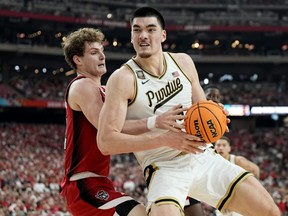 Purdue centre Zach Edey, right, backs into N.C. State forward Ben Middlebrooks during second half NCAA college basketball action at the Final Four men's tournament in Glendale, Ariz., Saturday, April 6, 2024.