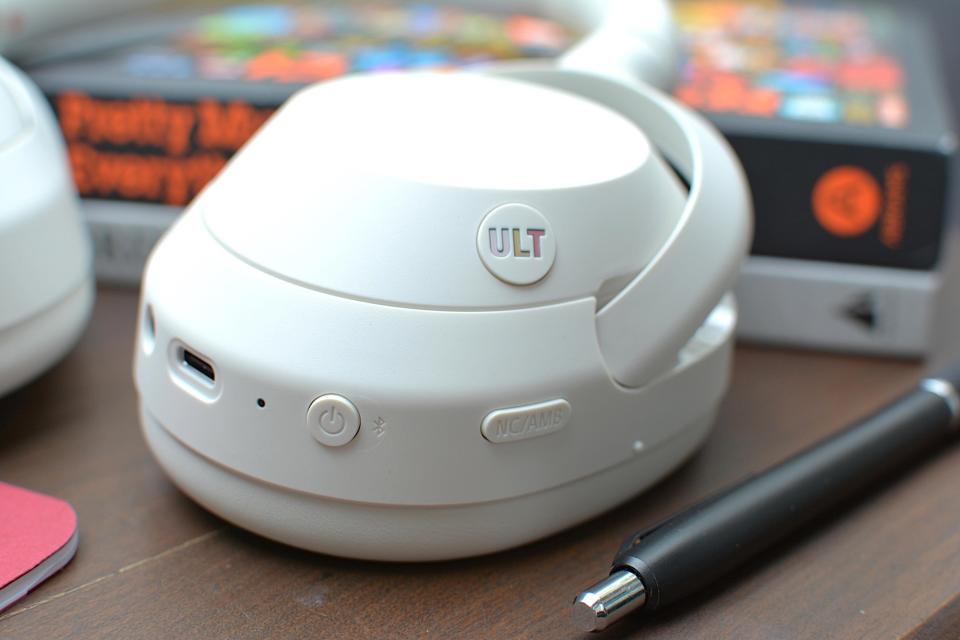 Controls detail of a set of white headphones with 3.5mm jack and USB-C port near power, ANC and ULT buttons.