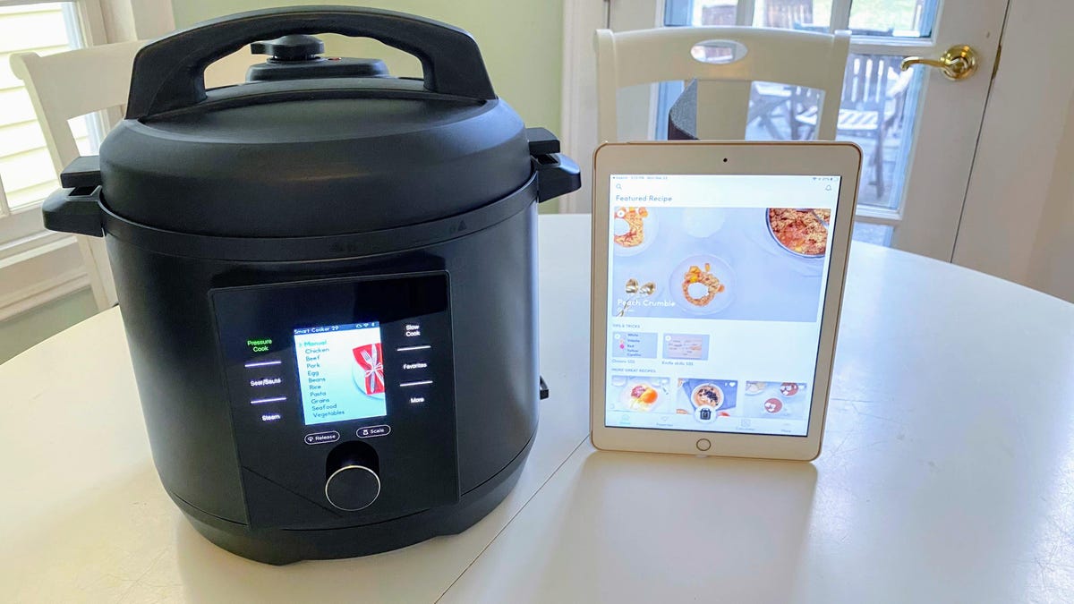 smart multicooker with tablet beside it