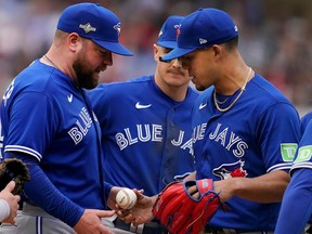 Toronto Blue Jays manager John Schneider (left) keeps making strange decisions