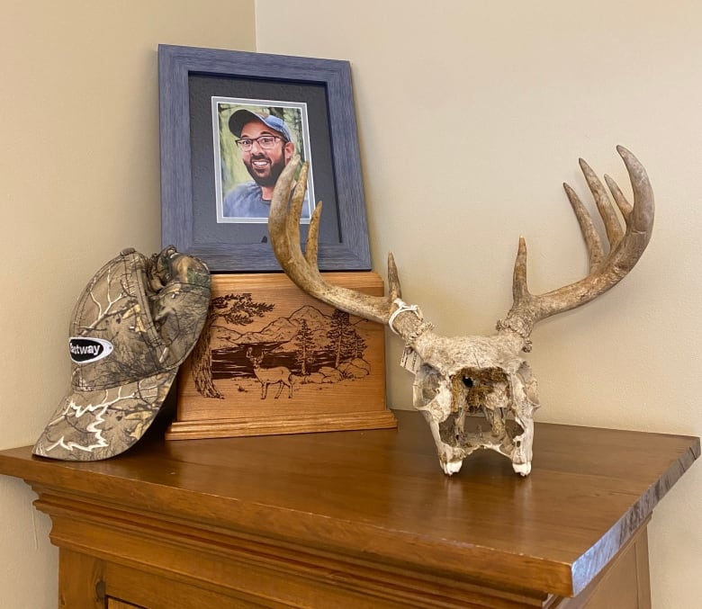 A photo with a hat and box and animal skull.