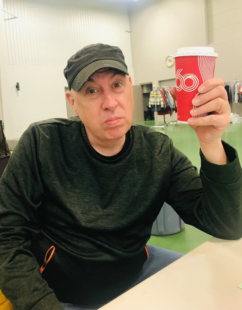 A man holding a coffee cup.