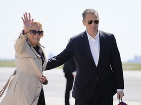 First lady Jill Biden waves as she walks with son Hunter Biden, to board Air Force One at John F. Kennedy International Airport, Friday, March 29, 2024, in New York.