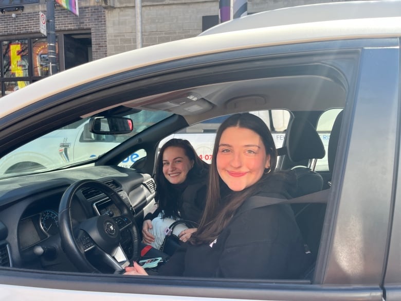 two young women inside a car