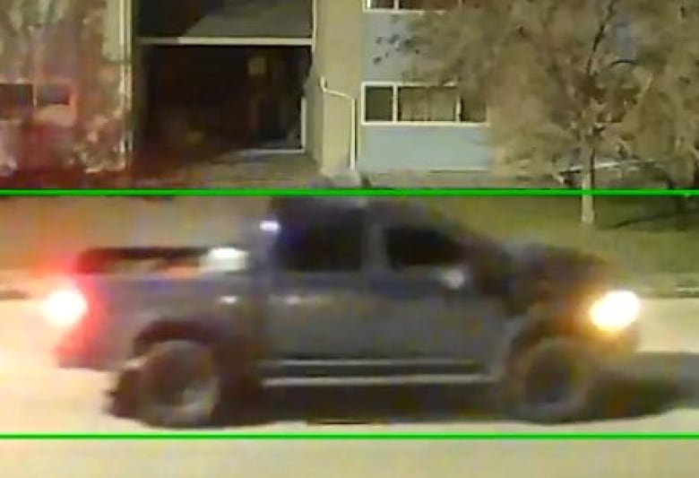 A black pickup truck is captured on CCTV footage.