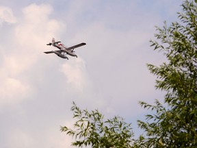 Water bomber flies low over treetops