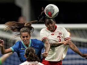 Canada's Kadeisha Buchanan (3) and Brazil's Jheniffer da Silva Cordinali Gouveia (9) go up for a head ball during the first half in a SheBelieves Cup women's soccer game, Saturday, April 6, 2024, in Atlanta.