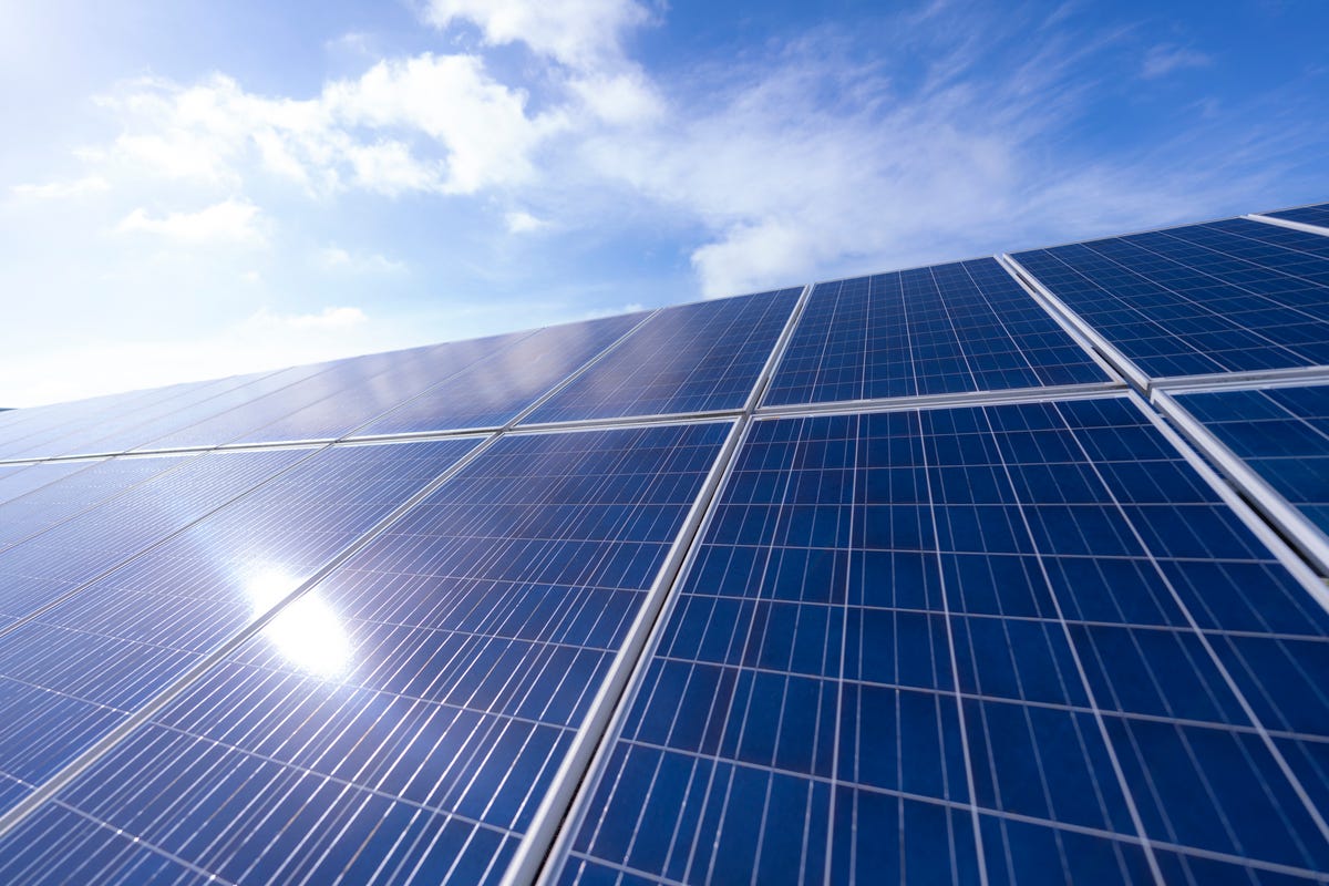 Solar panels and a partly cloudy sky.