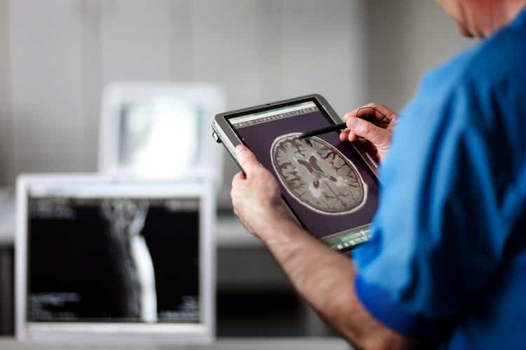 Doctor holding portable computer