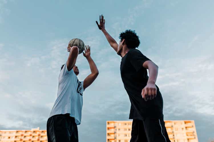 Friends playing one on one Basketball game