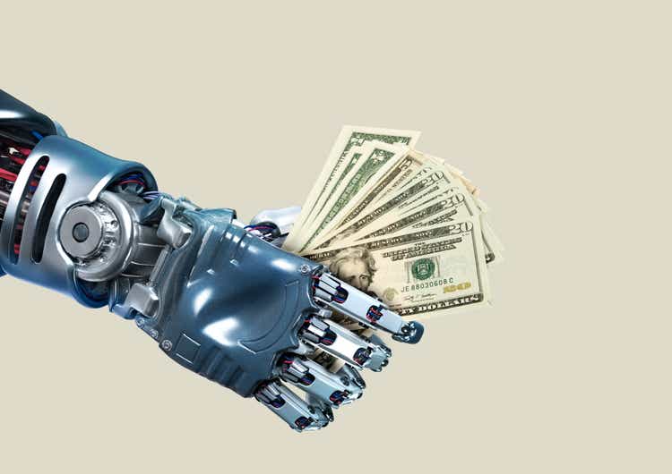 Robot hand holding lots of dollar notes