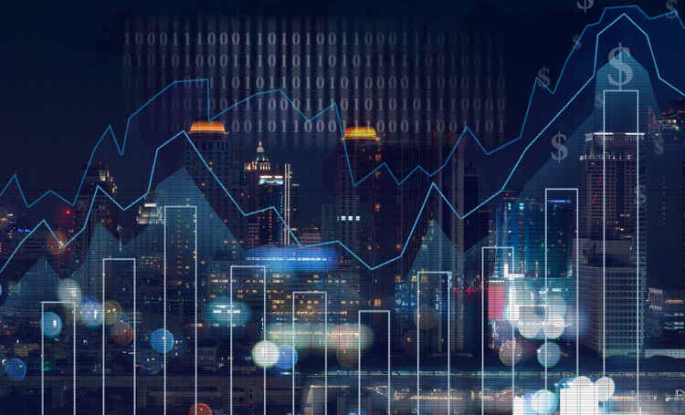 Trading graph on the cityscape at night and world map background,Business financial concept