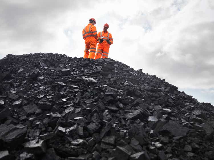 Coal Miners On Pile Of Coal