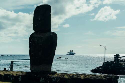 A moai on Rapa Nui (Easter Island), with the exploration vessel RV Falkor (too) in the background.