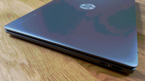 a close-up of the side of the hp chromebook plus 15.6-inch on a wooden table
