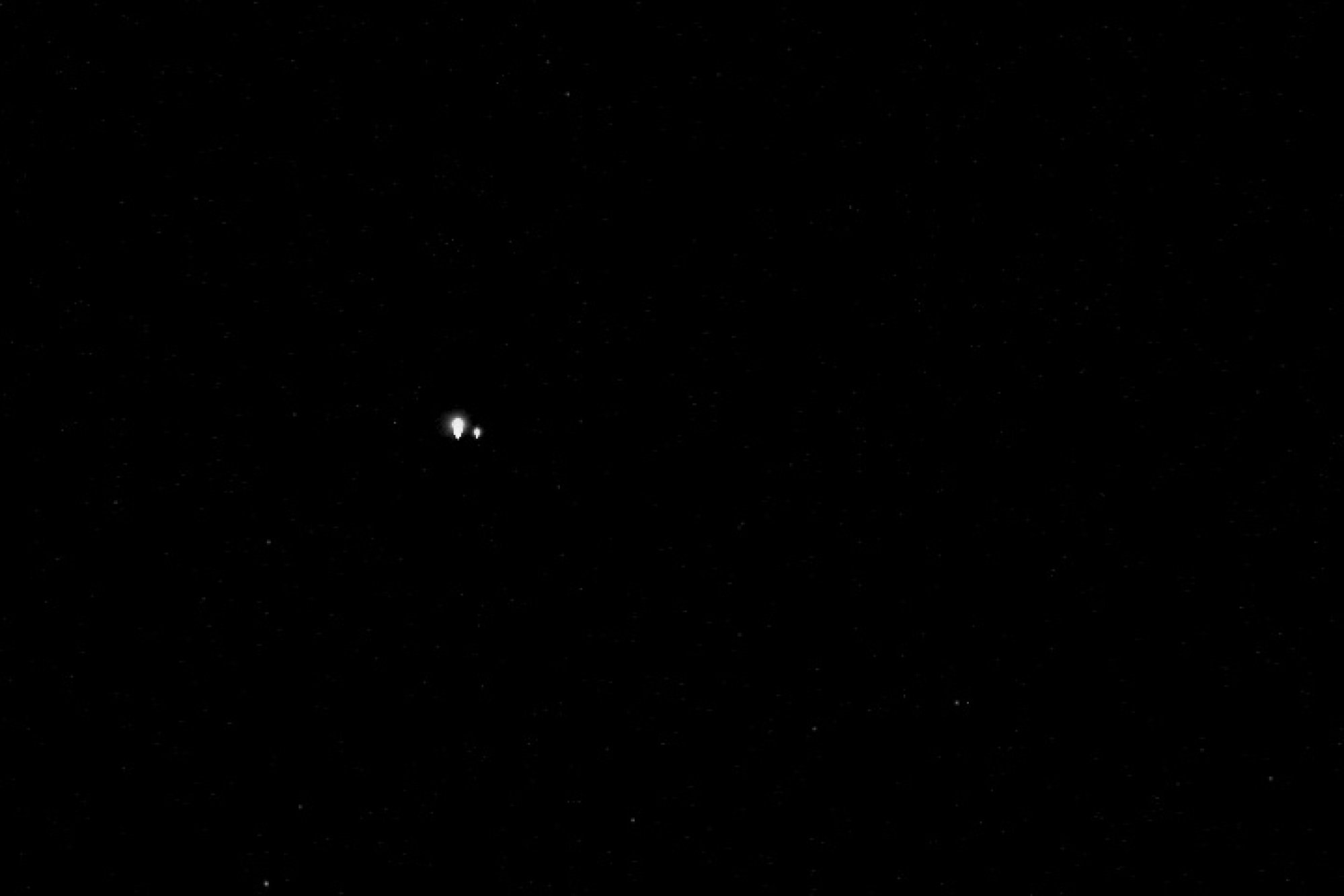 An overexposed Earth and moon as observed from 61 million miles away.