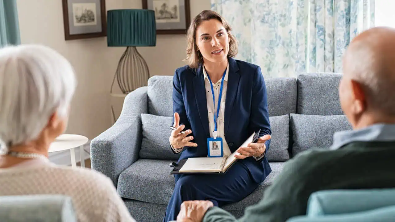 Social worker, talking to old man and woman for insurance plans on retirement.