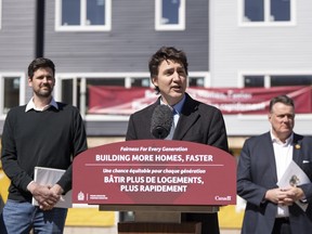 Prime Minister Justin Trudeau, centre, is flanked by Minister of Housing, Infrastructure and Communities Sean Fraser, left, and mayor of Halifax Mike Savage while making a housing announcement in Dartmouth, N.S. on Tuesday, April 2, 2024.