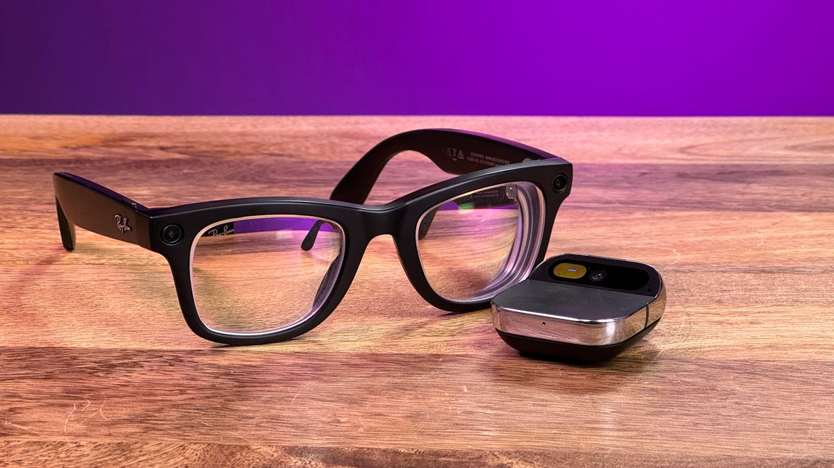 Humane AI Pin and Meta Ray-Ban glasses side by side on a wooden table