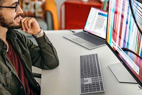 A man viewing a dell 4K monitor.