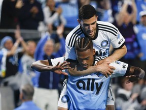 Charlotte FC forward Kerwin Vargas, front, celebrates with forward Liel Abada after scoring a goal against Toronto FC during the first half of an MLS soccer match in Charlotte, N.C., Saturday, April 13, 2024.