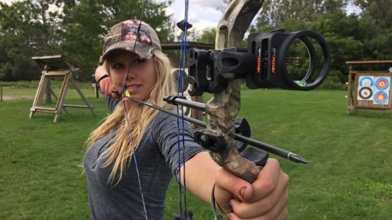 A woman holding an arrow.