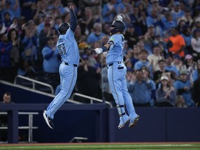 Toronto Blue Jays designated hitter Justin Turner (2) celebrates his solo homer with Blue Jays third base coach Carlos Febles (51) while playing against the Kansas City Royals during third inning American League MLB baseball action in Toronto on Monday, April 29, 2024.