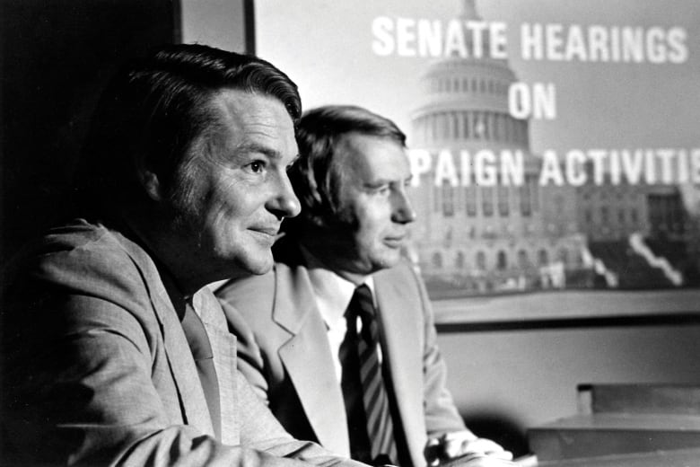 Two news anchors are shown in a black and white photo.