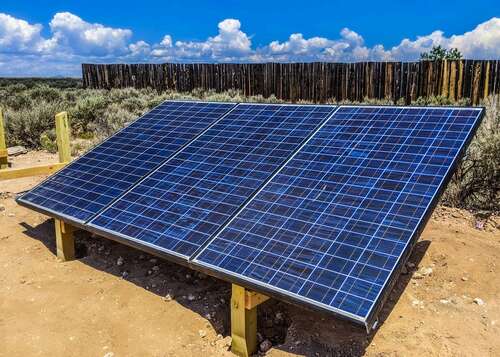 Solar panels mounted on a wooden ground mount.