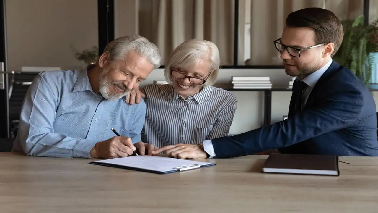 older-couple-signing-document