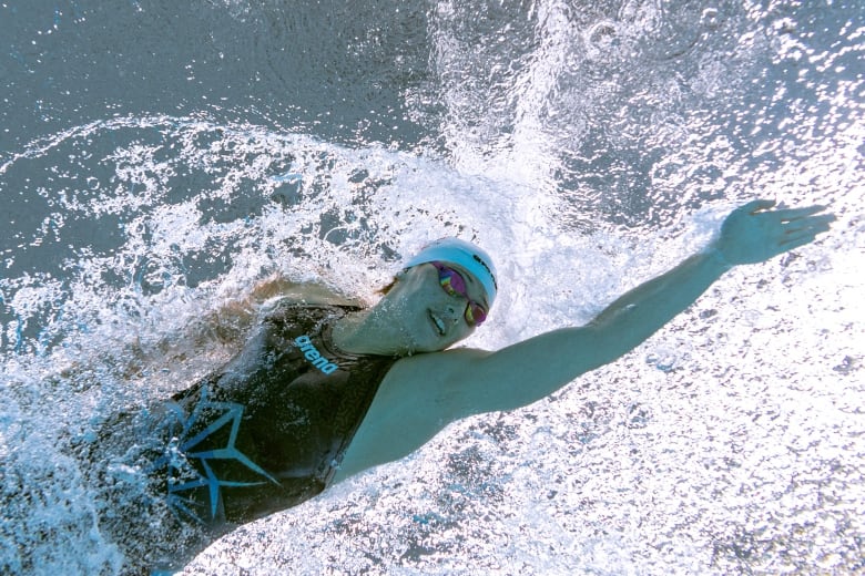 A swimmer glides through the water.