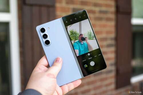 Person taking a selfie using the rear cameras on the Samsung Galaxy Z Fold 5.