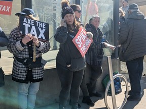 Demonstrators gather outside the office of Edmonton Centre Liberal MP Randy Boissonnault.