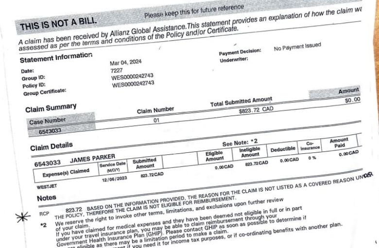 The photo shows an expense claim was denied because the reason was not listed as a covered reason in the policy.