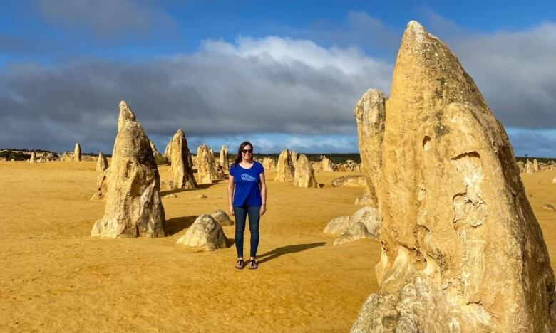 A woman in a field full of oddly shaped rocks