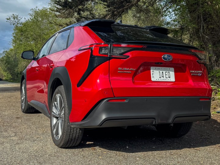 A rear three-quarters view of a red 2024 Subaru Solterra.