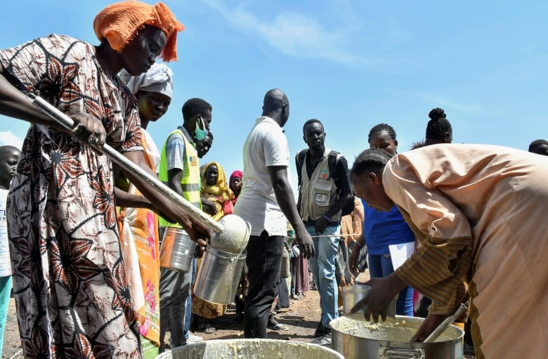 People line up to receive food rations.