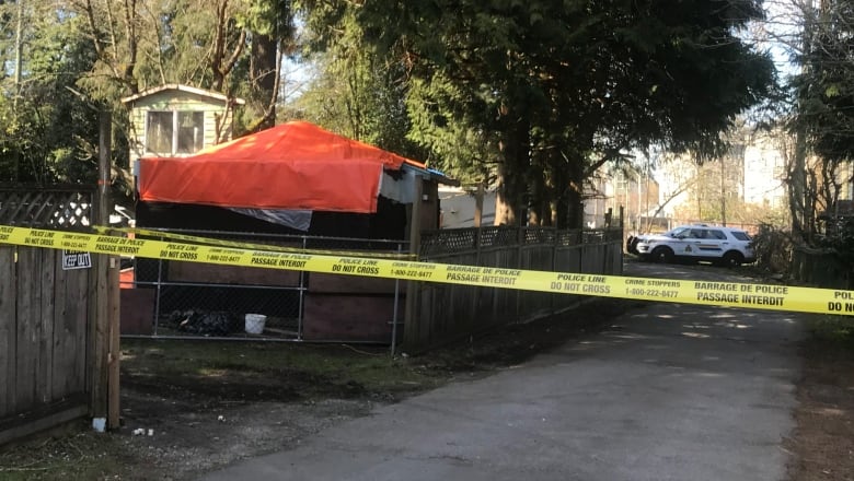 Yellow police tape stretches across a property.