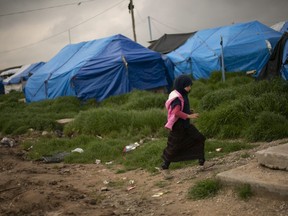 A girl walks through a tented area at Roj camp, where families of Islamic State supporters are held, near Derik, Syria on March 27, 2019.