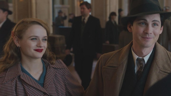 A young woman and man wearing period clothing talking to someone in a scene from We Were the Lucky Ones on Hulu.