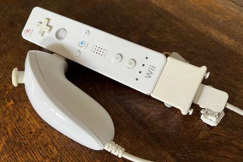 A slightly yellowed but still functional Wii Remote, Wii Motion Plus, and Wii Nunchuk.