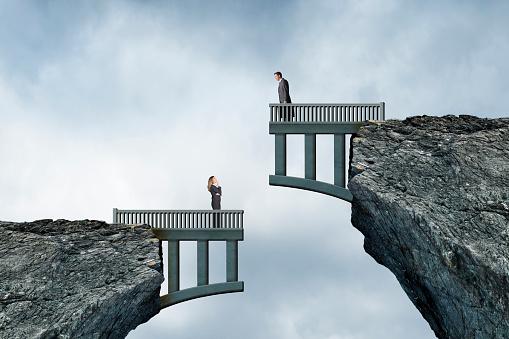 Woman Looking up At Man On Mismatched Bridge Construction